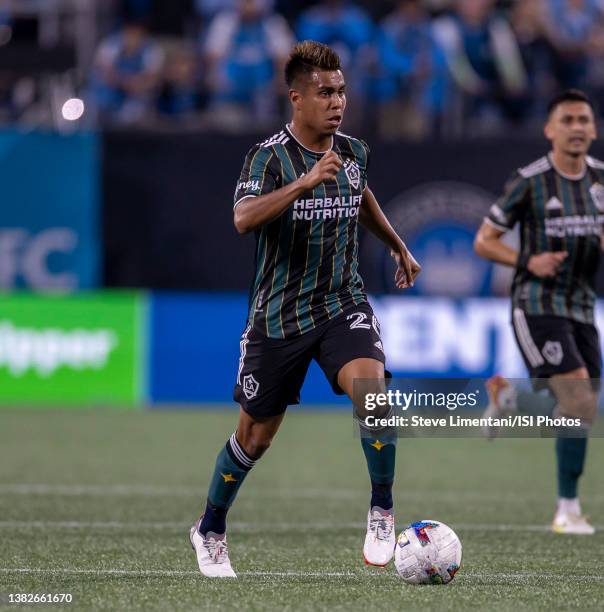 Efraín Álvarez advances the ball during a game between Los Angeles Galaxy and Charlotte FC at Bank of America Stadium on March 5, 2022 in Charlotte,...