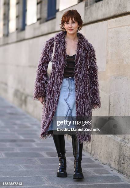 Alyssa Coscarelli is seen wearing a faux fur red and white coat, brown top, jean skirt and black boots outside the Sacai show during Paris Fashion...