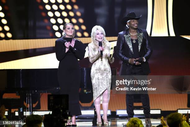 Co-hosts Gabby Barrett, Dolly Parton, and Jimmie Allen speak onstage during the 57th Academy of Country Music Awards at Allegiant Stadium on March...
