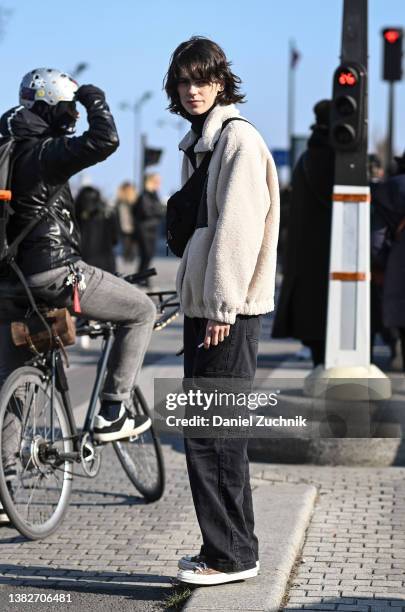 Model Miriam Sanchez is seen wearing a cream and black sweater, black cargo pants and a Prada bag outside the Louis Vuitton show during Paris Fashion...