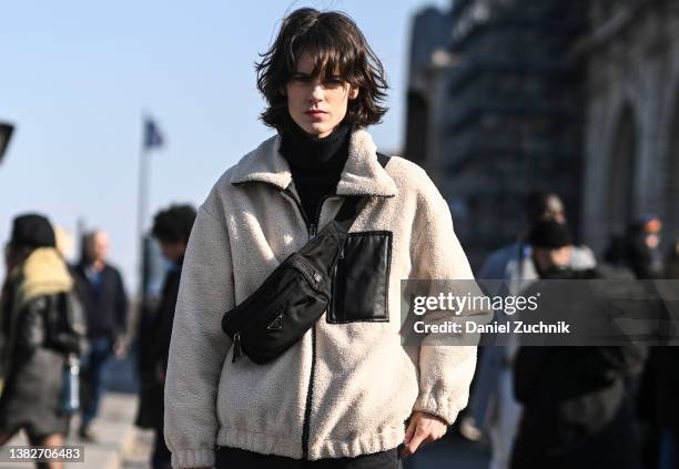 Model Miriam Sanchez is seen wearing a cream and black sweater, black cargo pants and a Prada bag outside the Louis Vuitton show during Paris Fashion...