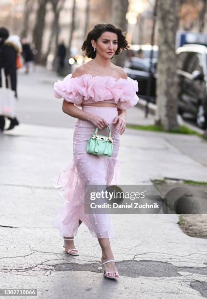 Alexandra Pereira is seen wearing pink Giambatista Valli top and skirt and Giambatista Valli green bag outside the Giambatista Valli show during...