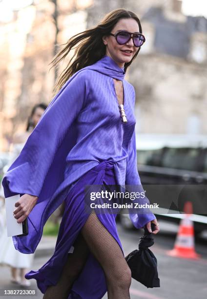Ece Sukan is seen wearing a purple dress outside the Giambatista Valli show during Paris Fashion Week A/W 2022 on March 07, 2022 in Paris, France.