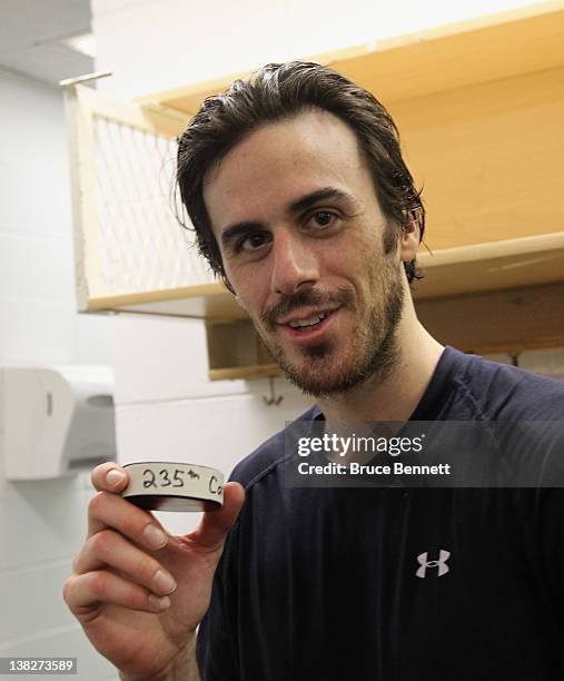 Ryan Miller of the Buffalo Sabres poses with the winning puck following the Sabres 4-3 shoot out victory over the New York Islanders at the Nassau...