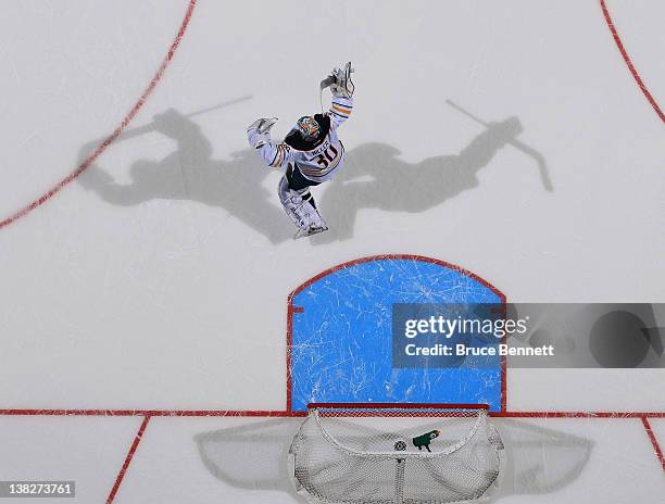 Ryan Miller of the Buffalo Sabres celebrates the Sabres 4-3 shoot out victory over the New York Islanders at the Nassau Veterans Memorial Coliseum on...