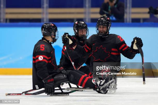 Anton Jacobs-Webb and Garrett Riley of Team Canada celebrate after assisting on a goal in the second period against Team South Korea during the...