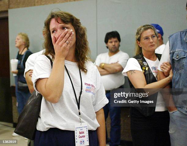 Members of the International Association of Machinists Union workers at Boeing react to the announcement of the results of a contract vote at IAM's...