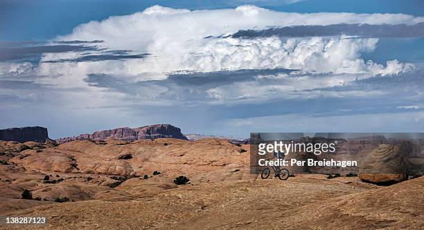 a mountain biker riding on slickrock, moab, utah - slickrock trail stock pictures, royalty-free photos & images