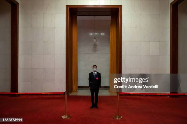 Security guard stands inside the Great Hall of the People before the beginning of the Second Plenary Session of the Fifth Session of the 13th...