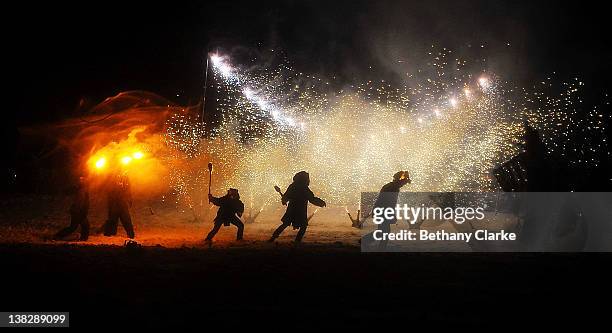 In driving snow torches representing the return of the sun are used in a symbolic battle against winter on February 4, 2012 in Huddersfield, England....