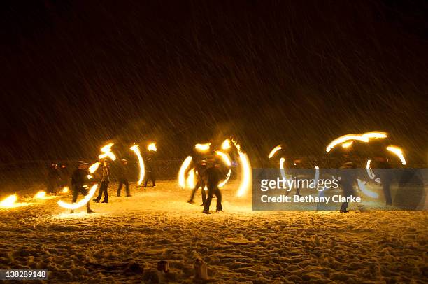 In driving snow torches representing the return of the sun are used in a symbolic battle against winter on February 4, 2012 in Huddersfield, England....
