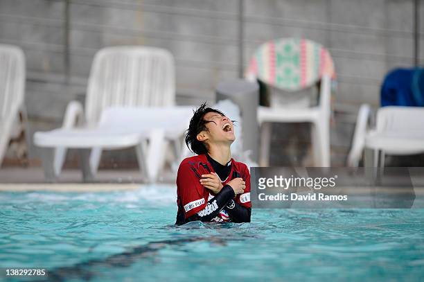 Chiaki Minamiyama of INAC Kobe Leonessa Ladies reacts to the water temperature after being thrown into an outdoor swimming pool by her teammates,...