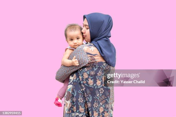 portrait of mother and baby daughter - hijab woman from behind stock pictures, royalty-free photos & images