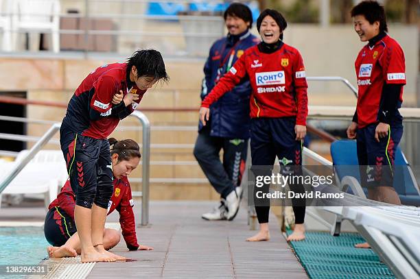 Chiaki Minamiyama of INAC Kobe Leonessa Ladies reacts to the water temperature after being thrown into an outdoor swimming pool by her teammates,...