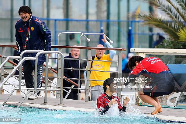 Chiaki Minamiyama of INAC Kobe Leonessa Ladies reacts to the water temperature after being thrown into an outdoor swimming pool by her teammates,...