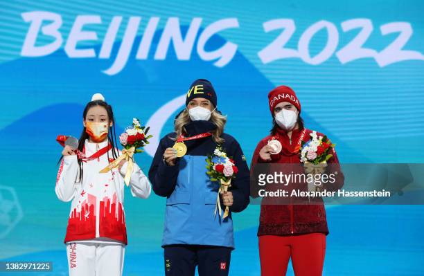 Gold medallist Ebba Aarsjoe of Team Sweden , Silver medallist Mengqiu Zhang of Team China and Bronze medallist Alana Ramsay of Team Canada celebrate...