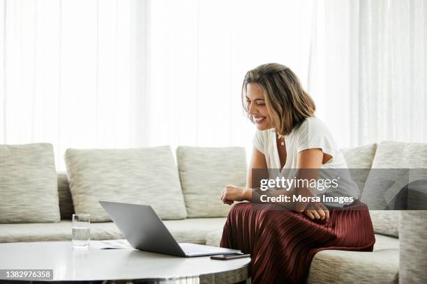 entrepreneur working on laptop in hotel room - skirt stock pictures, royalty-free photos & images