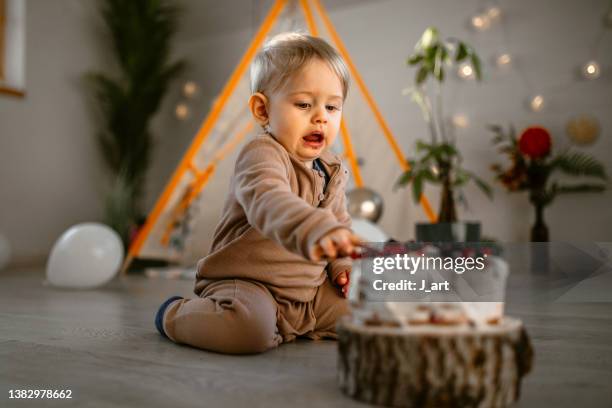 cute little messy baby boy celebrating his first birthday - party aftermath stock-fotos und bilder