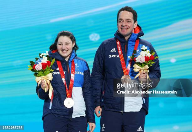 Bronze medallist Menna Fitzpatrick of Team Great Britain and guide Gary Smith celebrate during the Women's Para Alpine Skiing Super Combined Vision...
