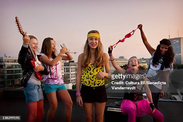 teenage girls playing music on roof - girls in bras photos 個照片及圖片檔