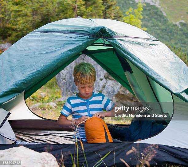 boy unpacking sleeping bag in tent - open day 6 stock pictures, royalty-free photos & images