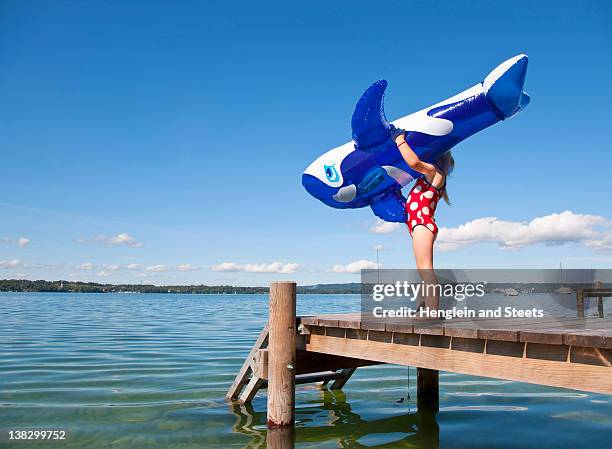 girl holding inflatable whale on dock - starnberger see stock pictures, royalty-free photos & images