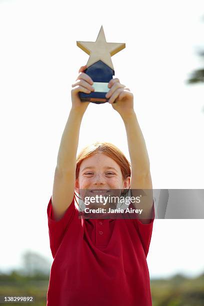 girl cheering with trophy outdoors - people holding trophy stock pictures, royalty-free photos & images