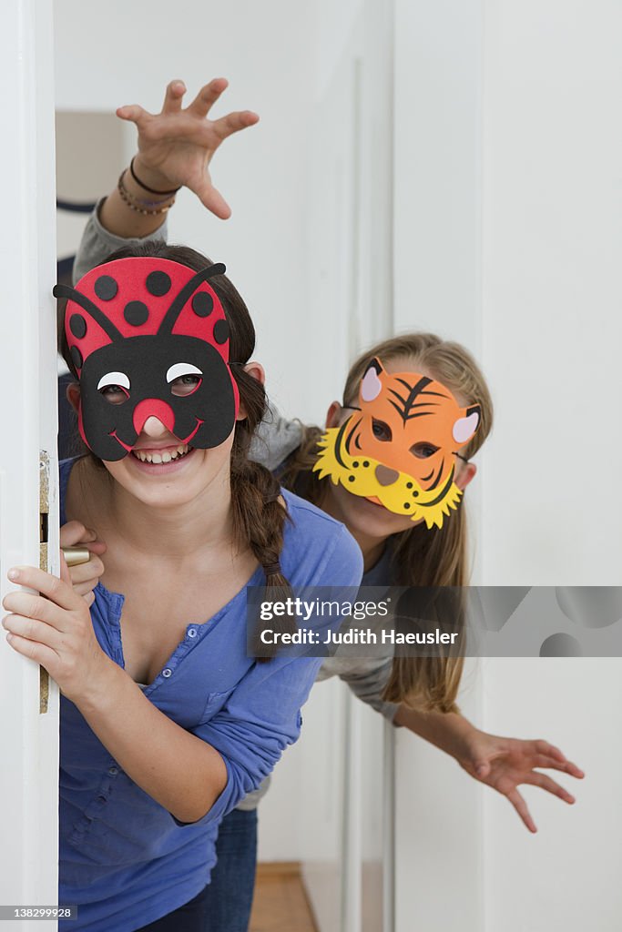 Smiling girls wearing colorful masks