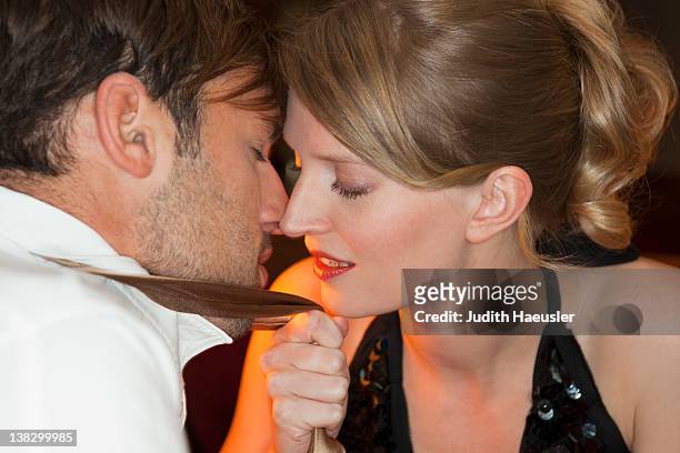 couple touching noses in restaurant - temptation stock-fotos und bilder