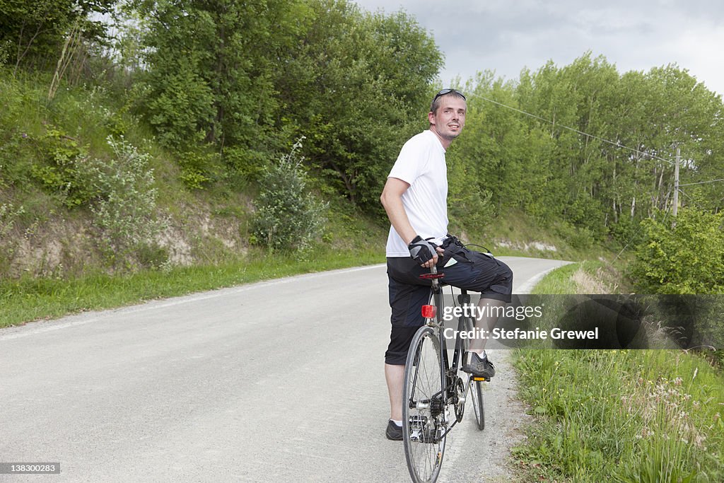 Man riding bicycle on dirt road