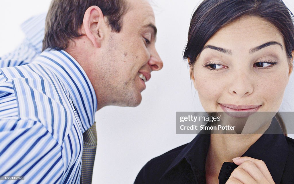 Business people whispering in office