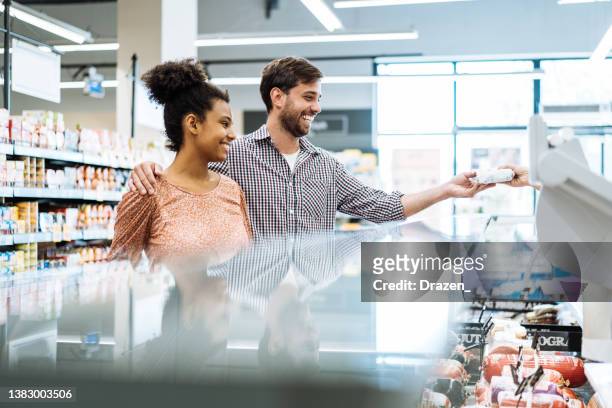 female butcher in supermarket serving customers - butcher portrait imagens e fotografias de stock