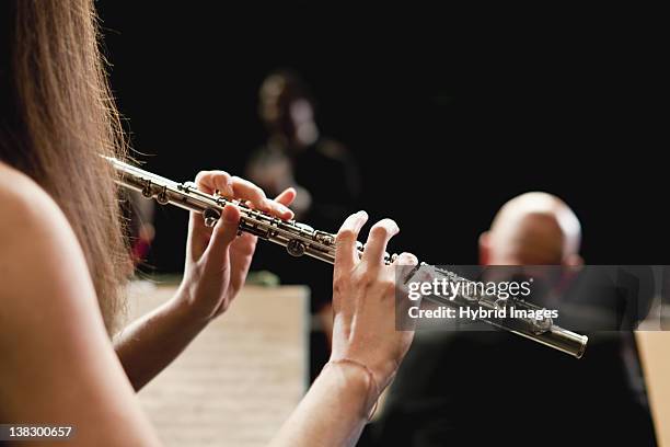 flute player in orchestra - flauto foto e immagini stock