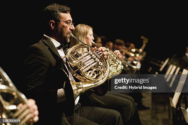 french horn players in orchestra - orchestra foto e immagini stock