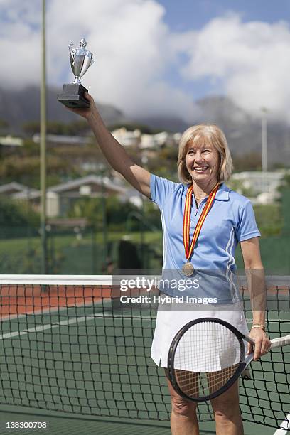 older woman with trophy on tennis court - life after stroke awards 2011 ストックフォトと画像