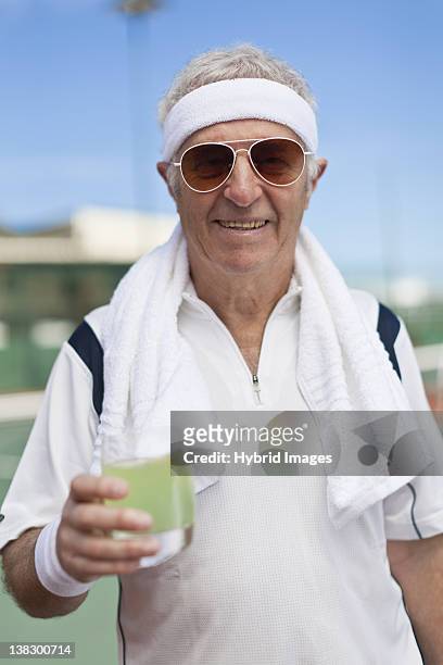 ältere mann, trinkt limonade im freien - stirnband stock-fotos und bilder