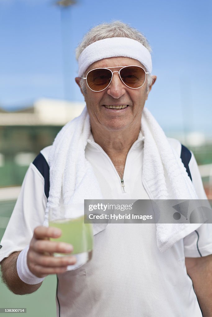 Older man drinking lemonade outdoors