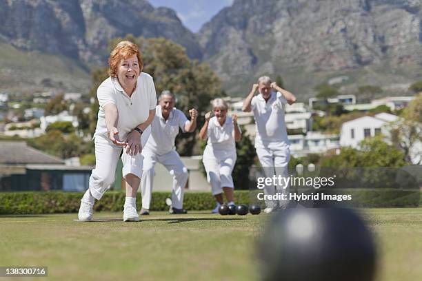 older couples playing lawn bowling - senior men bowling stock pictures, royalty-free photos & images