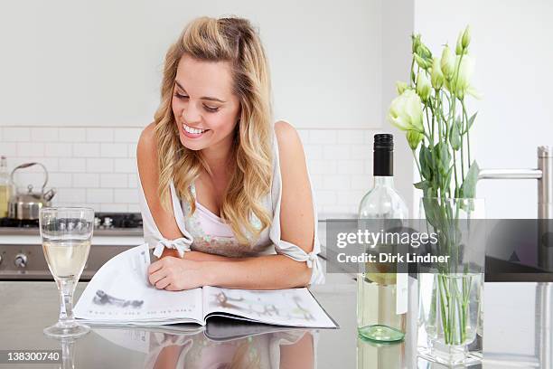 woman relaxing with wine and magazine - glass magazine stock pictures, royalty-free photos & images