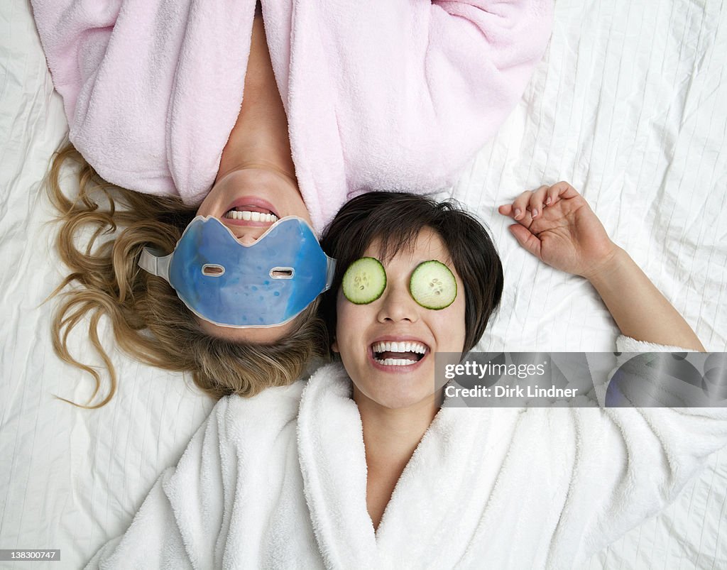 Women in bathrobes wearing eye masks