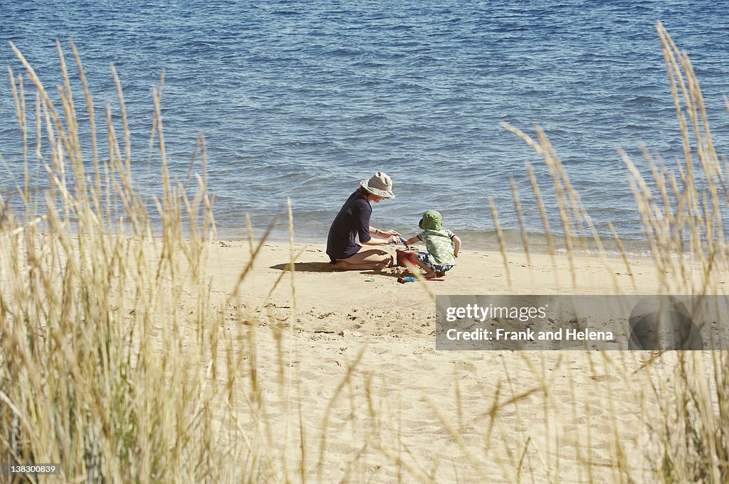 Mother and child playing on beach