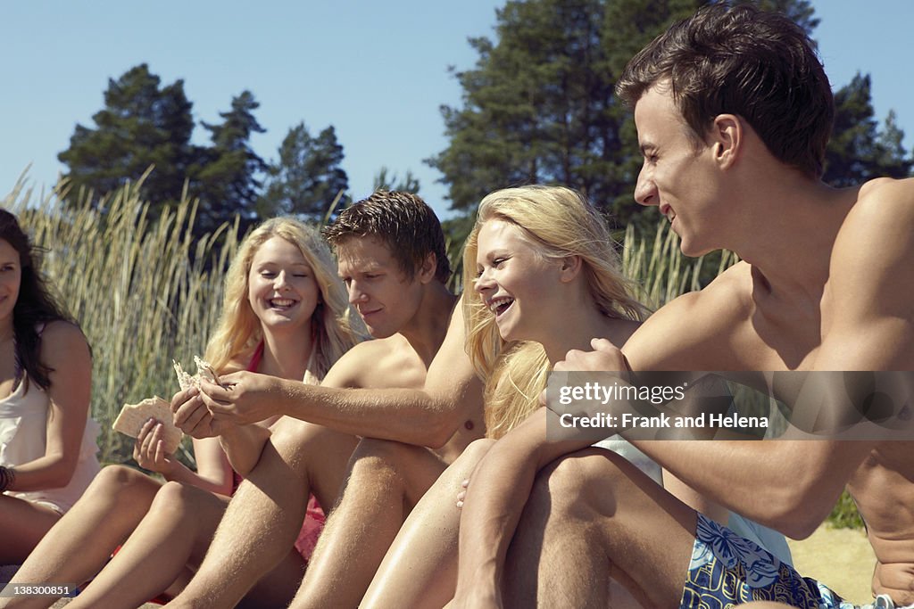 Friends sitting together on beach