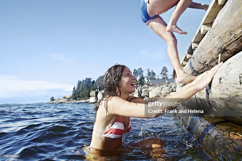 Teenage girls climbing pier