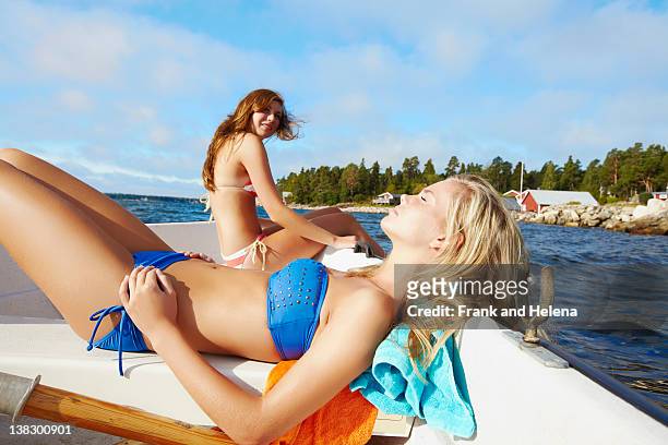 teenage girls relaxing on sailboat - pretty girls in swimsuits bildbanksfoton och bilder