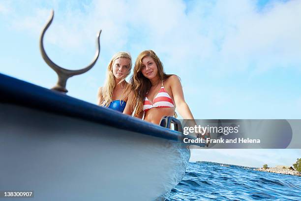 teenage girls relaxing on sailboat - rowboat stockfoto's en -beelden