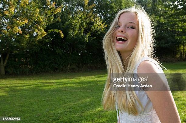 teenage girl laughing outdoors - 14 year old blonde girl stock pictures, royalty-free photos & images