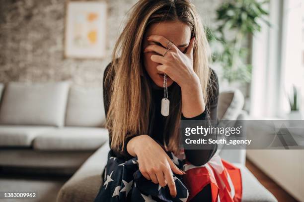 sad widow crying because her husband has died in the war - widow stock pictures, royalty-free photos & images