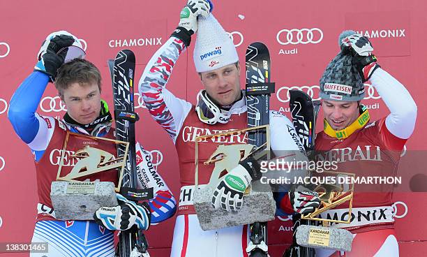 France's Alexis Pinturault, Austria's Romed Baumann and Switzerland's Beate Feuz pose on the podium with their awards after the Kandahar Men's Super...