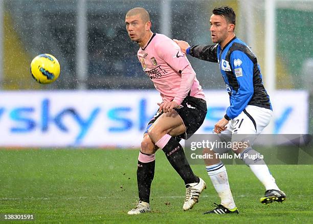 Massimo Donati of Palermo and Luca Cigarini of Atalanta compete for the ball during the Serie A match between US Citta di Palermo and Atalanta BC at...