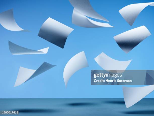 white paper flying - paper flying stock pictures, royalty-free photos & images